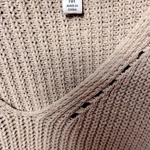Beige v neck sweater.